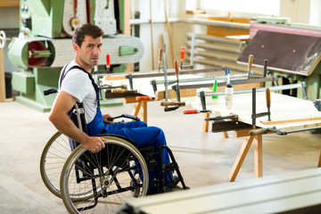 worker in wheelchair in a carpenter's workshop