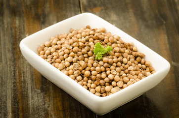 Coriander seed in the bowl on wooden background,food ingredient,seasoning