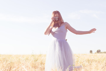 Fototapeta na wymiar beautiful outdoors photographer in long blue ball dress