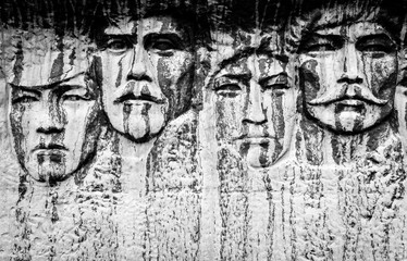 Human Faces Carved in Black Stone