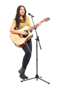 Female signer playing on acoustic guitar