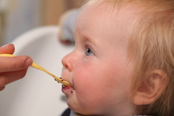 feeding baby with a spoon