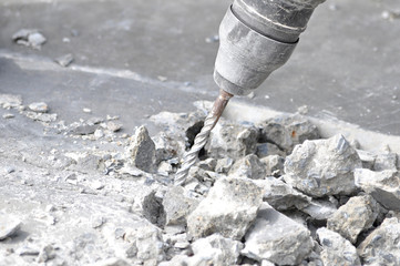 Drilling machine breaking concrete floor