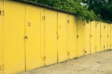 Several yellow numbered car garage outdoors