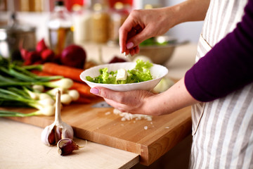 Young woman cutting vegetables in the kitchen