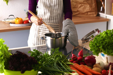 Young woman cutting vegetables in the kitchen