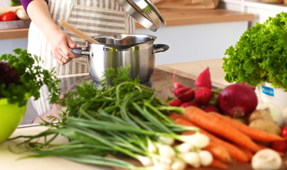 Young woman cutting vegetables in the kitchen