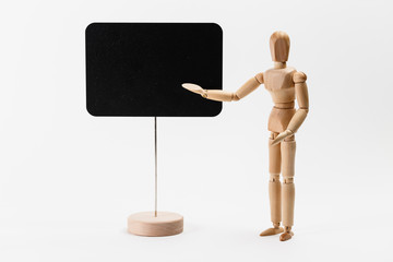 Wooden mannequin pointing on a canvas, as presenting something