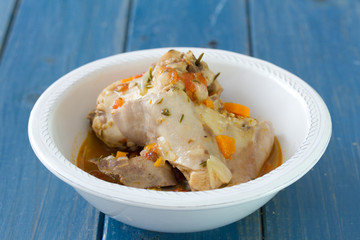 rabbit in white bowl on blue wooden background