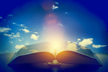 Open old book, light from the sky, heaven. Education, religion concept