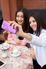 Happy Young asian women making selfie photo on smartphone