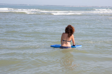 Woman with body board at the sea