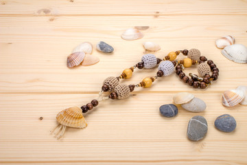 Necklaces handmade pendant from sea shells on the background lig