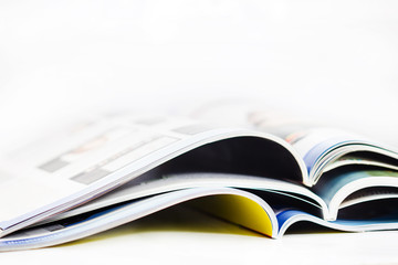 a pile of magazines close up on white background