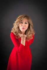 Fototapeta premium Beautiful woman doing different expressions in different sets of clothes: kiss