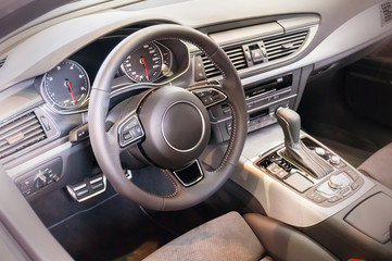 Obraz premium Black luxury car Interior - steering wheel, shift lever and dash