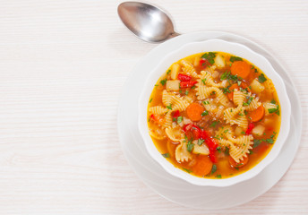 Fresh vegetable soup with farfalle pasta