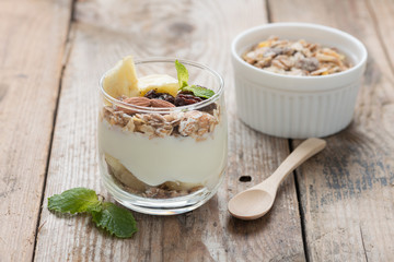 Yogurt with muesli in small glass.