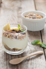 Yogurt with muesli in small glass.