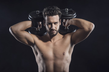 Fototapeta na wymiar Attractive man weightlifting