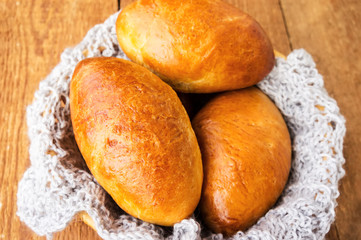 Pasties stuffed meat on a dark wood background, selective focus