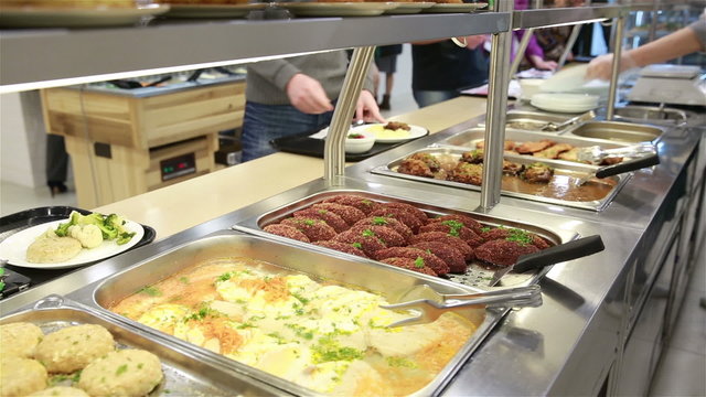 Lunch in the canteen. The waiter serves visitors.