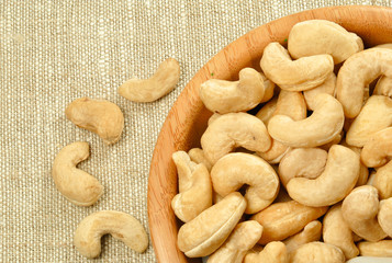 cashew nuts in a bowl on linen background