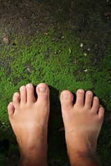 Selfie of woman feet with grass moss