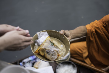 give alms to a Buddhist monk while on board .