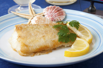 floured cod cooked in a pan