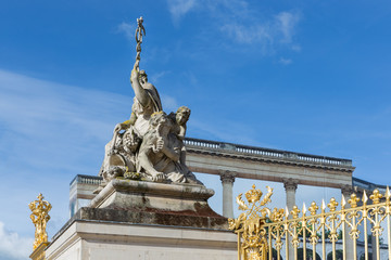 Statue near the entrance of Palace Versailles in Paris, France