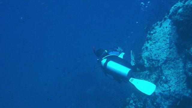Man scuba diving trainning practice underwater with corall reef