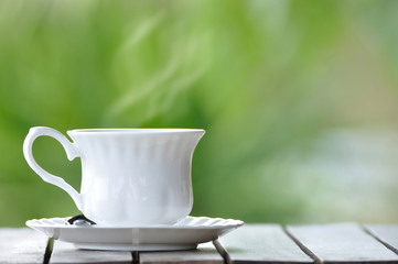 Coffee and tea cup on wooden table and blur background.