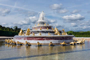 Ornamental pond with fountains in garden Palace Versailles Paris