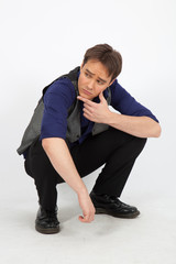 handsome man doing different expressions in different sets of clothes: kneeling