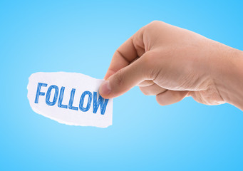 Piece of paper with the word Follow with blue background