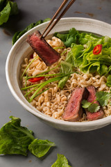 A bowl of Chinese ramen noodles with beef, Chinese cabbage, chil
