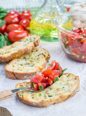 Bruschetta with tomatoes, herbs and oil on toasted garlic cheese bread