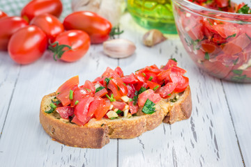Bruschetta with tomatoes, herbs and oil on toasted garlic cheese bread