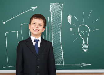 boy in suit show graphs on school board