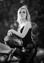 Fototapeta na wymiar Young sexy woman sitting on red motorcycle