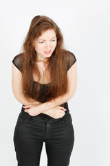 Fototapeta premium Beautiful businesswoman doing different expressions in different sets of clothes: stomachache