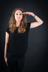 Beautiful woman doing different expressions in different sets of clothes: at attention