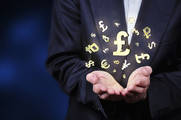 Currency gold symbols in a man hand