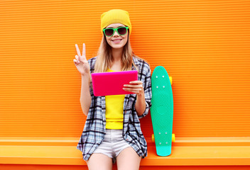 Fashion and technology concept - stylish pretty cool girl with d