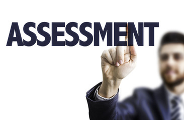 Business man pointing the text: Assessment