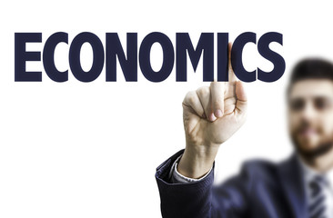 Business man pointing the text: Economics