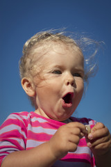 little girl walking by the sea.