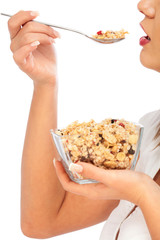 Young woman eating cereal breakfast