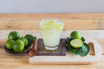 Lemonade with fresh lemon  on wooden table